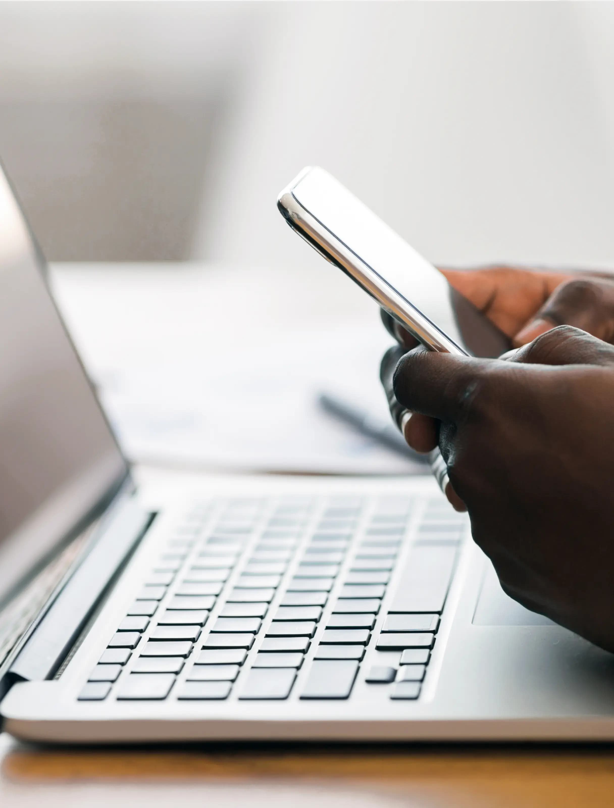 Contact us - person using smartphone and laptop